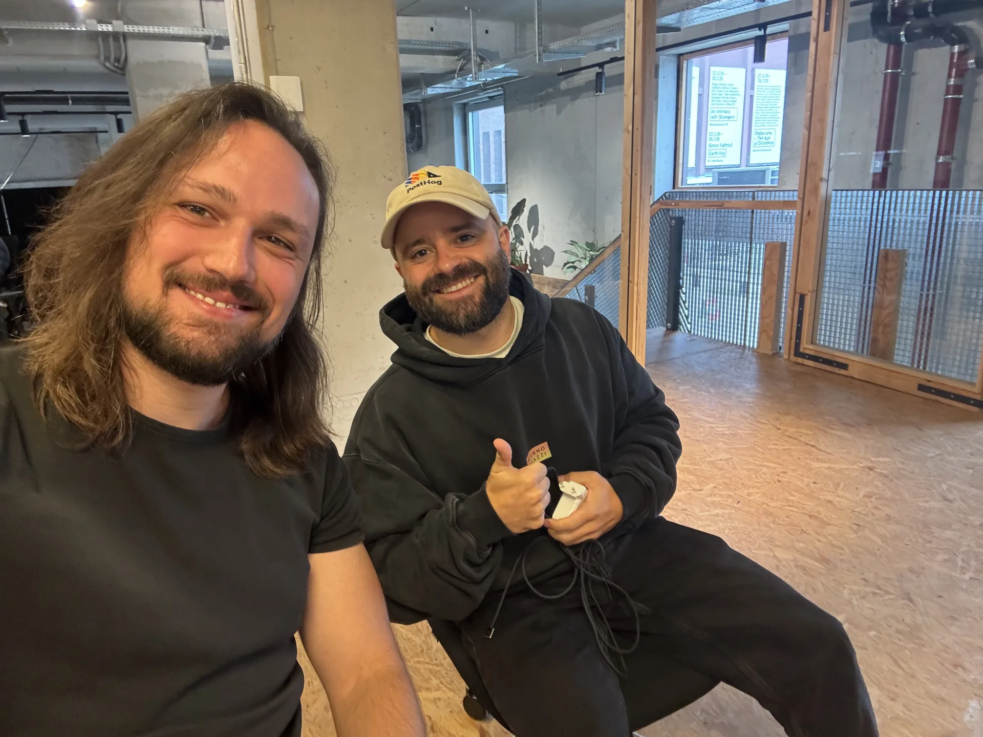 Peppe and Meikel smiling together while setting up the event
