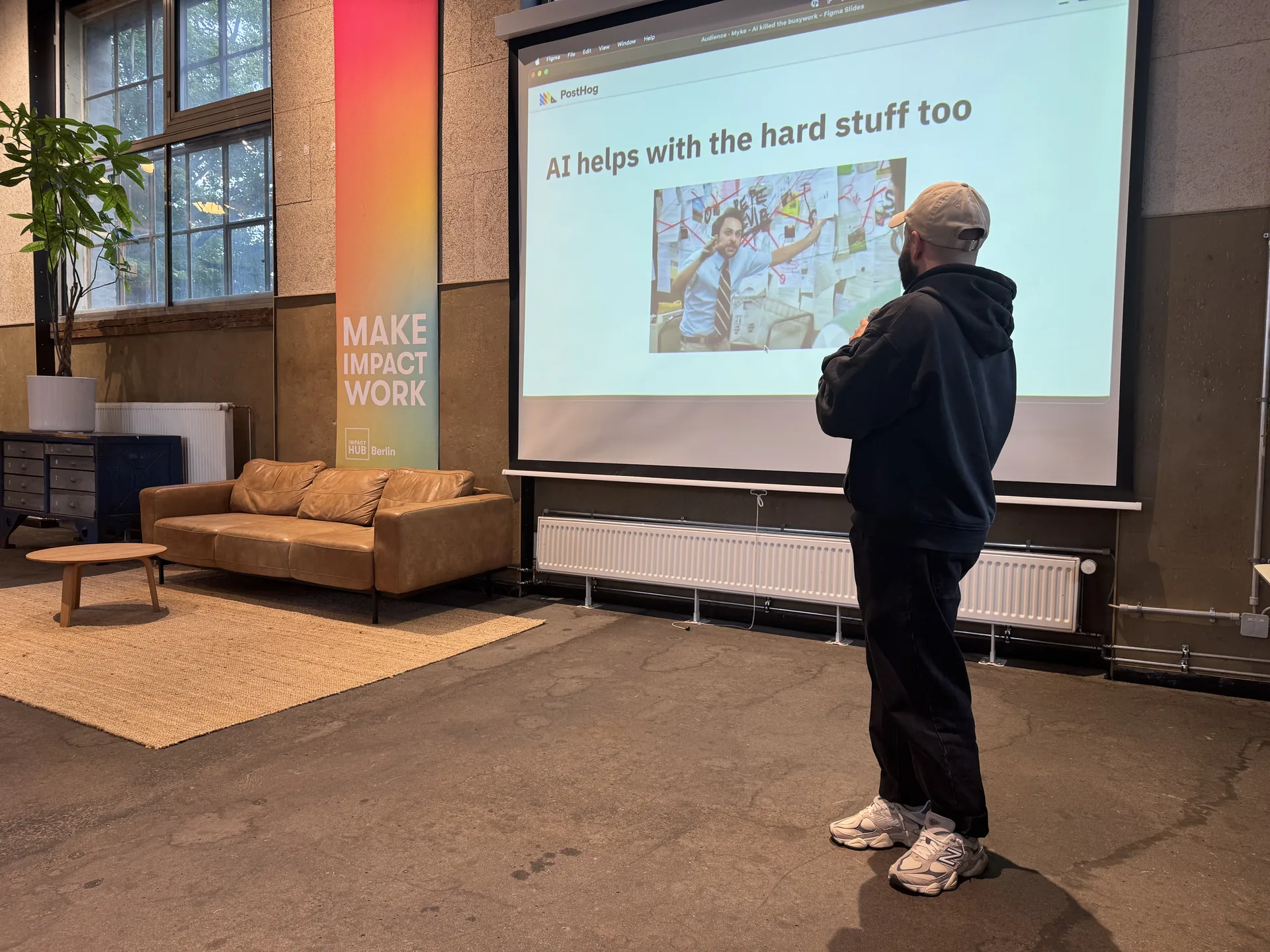 A speaker presenting a talk about AI and product engineering