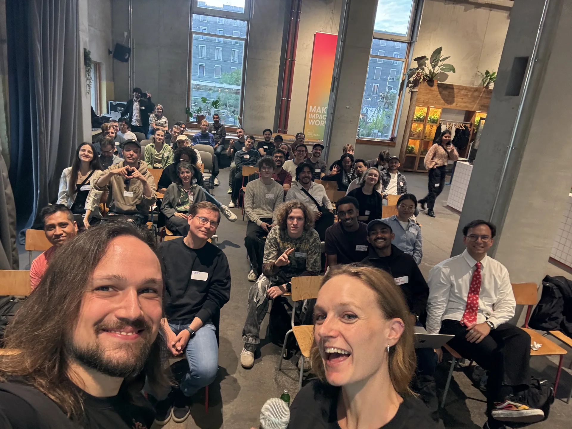 Peppe and Else taking a selfie with the audience at Impact Hub Berlin